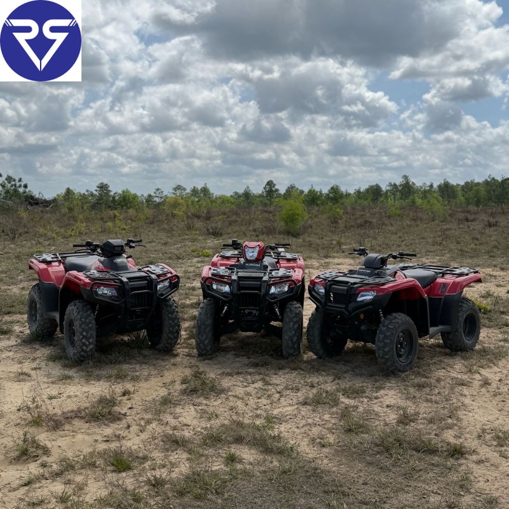 Multiple Honda ATV models parked on open off-road trail 