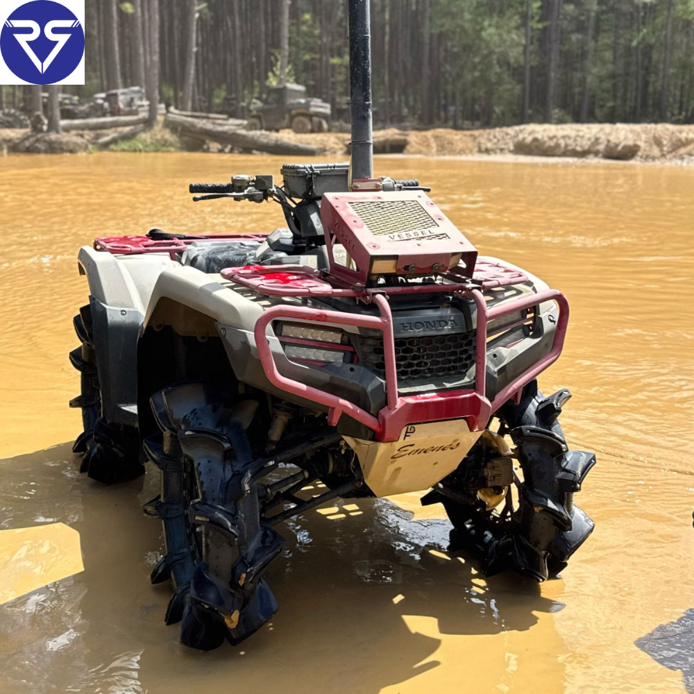 Honda ATV with snorkel and mud tires navigating deep muddy water, equipped with lifted suspension and off-road modifications in a forest trail setting.