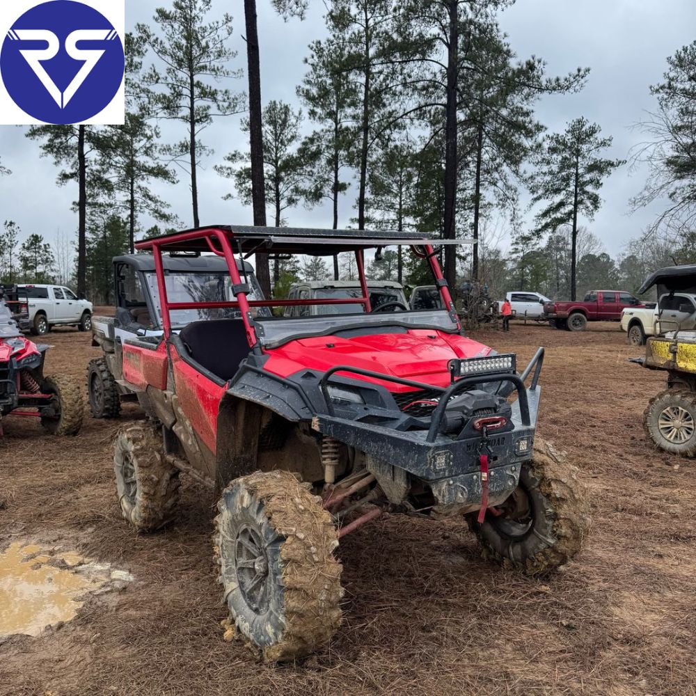 Red ATV with mud on tires 